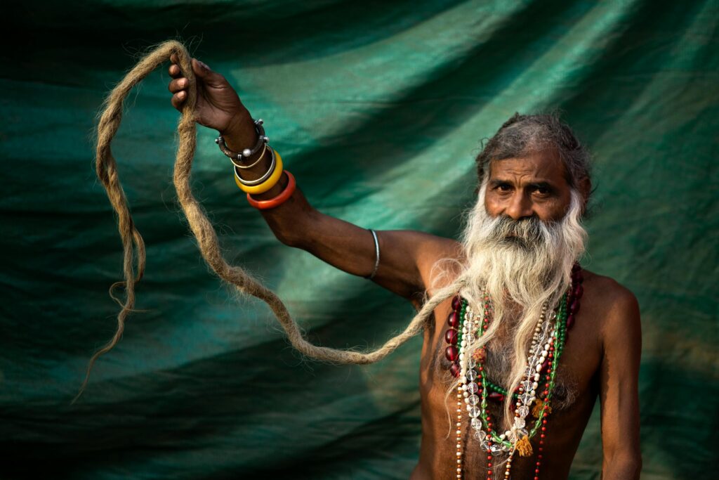 what is maha kumbh 2025, details, information, stay, importance, Elderly Naga Sadhu with long dreadlocks, showcasing traditional attire and spiritual reverence.